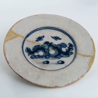 Faience plate on stand, blue decor on white background, fruit and insects, plate crockery holder soil find ceramic pottery glaze