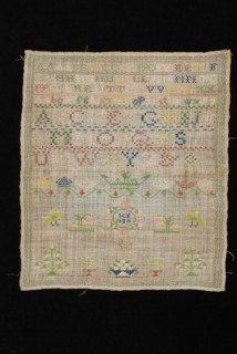 Sampler or letterlap worked in cross stitch in colored silk on loosely woven linen, marked SCF 1824, lettercloth sampler