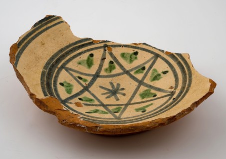 Fragment red earthenware bowl with white background and blue star shape with green accents, bowl dish bowl tableware holder soil