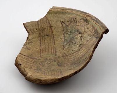Fragment earthenware bowl with yellow surface, purple cross shape with green accents, bowl crockery holder soil find ceramic