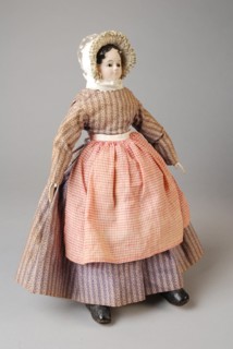 mw. Andres-Van Embden, Dollhouse doll, papier-mâché head with inlaid brown glass eyes, wooden forearms, fabric body and legs