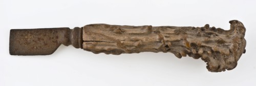 Knife with iron blade and legs raises with capriciously carved decoration, knife cutlery soil find iron bone metal, archeology