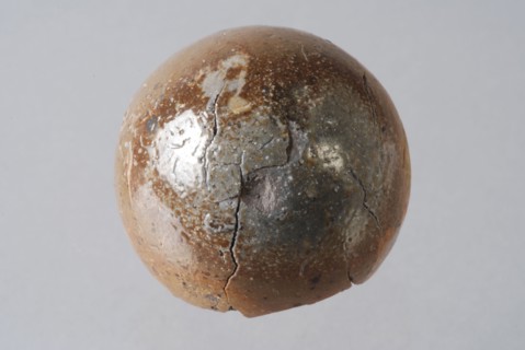 Stone sphere with brown glaze, marble or ball, marble toy relaxant bullet ammunition soil find ceramic stoneware clay engobe