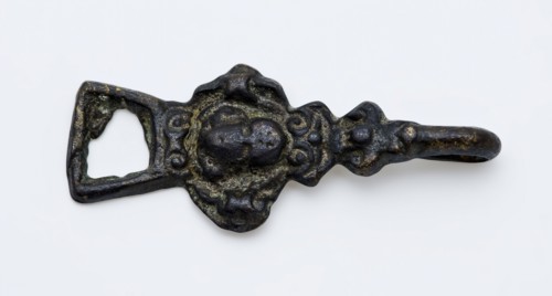 Coat hook or coat closure, cherub head on front, with eye and hook at ends, closure clothing accessory clothing soil find copper