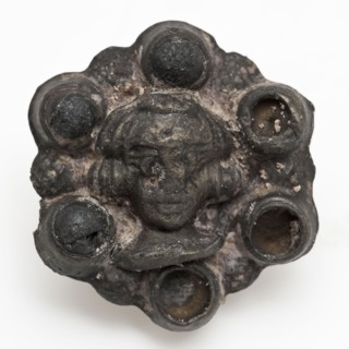 Rosette-shaped batter with face in the middle, ornament batter ground find tin metal, cast Fittings in the form of rosette
