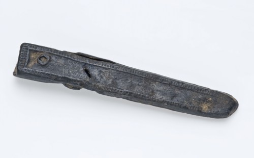 Narrow pewter belt tongue delineated with thin edge shading, fitting belt clothing accessory clothing soil find tin metal