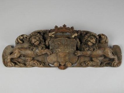 Carved city coat of arms of Rotterdam, two lions holding crowned coat of arms, coat of arms information form carvings sculpture
