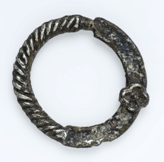 Annular buckle with twisted edge and small rosette, ornamental buckle, buckle fastener component soil find tin? silver? metal
