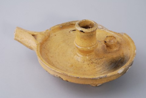 Yellow glazed earthenware candlestick, with handle and candle holder, sconce candlestick lighting means floorfound ceramics