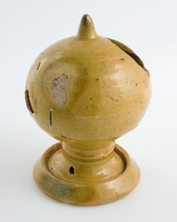 Yellow glazed piggy bank, ball with slot, on foot, piggy bank holder earth discovery ceramic earthenware glaze lead glaze, hand