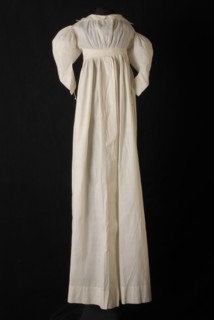 White cotton baby nightgown, with sheepskin sleeves, embroidery stitches mid front, on collar and on belt, nightgown sleepwear