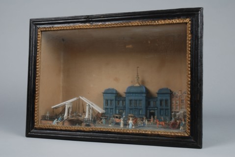 Diorama or viewing box of detailed, polychrome painted cut from Beurs with some buildings next to it, diorama footage cardboard