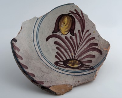 Fragment of dish, yellow shard, polychrome decorated, depicting flowering plant, dish crockery holder soil find ceramic