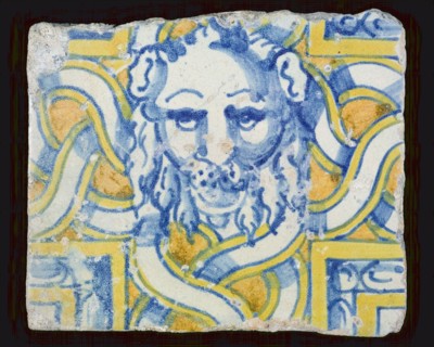 Tile, multicolored, blue, yellow, orange, with lion's head in plaiting, wall tile tile sculpture ceramics pottery glaze tin