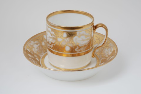 White cup and saucer with gold colored band with acorn and leaf decoration, cup and saucer drinkware tableware holder coffee