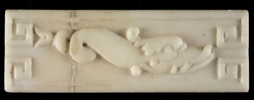 White marble relief, dolphin, with two curls in tail, meander-ornament in corners, relief marble stone, Rotterdam City Triangle