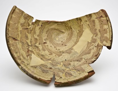 Fragment of earthenware dish with decoration in sludge technology, on stand, dish bowl tableware holder soil find ceramic