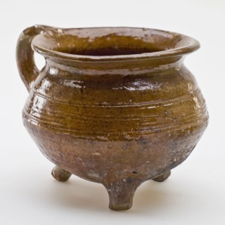 Pottery cooking pot, cooking jug with outstanding top edge, one sausage ear, on three legs, cooking pot crockery holder