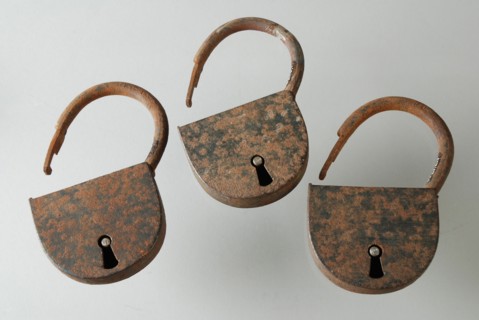 Three similar padlocks with matching keys, which belong to the storage handles of the oak coffin, padlock lock closing device