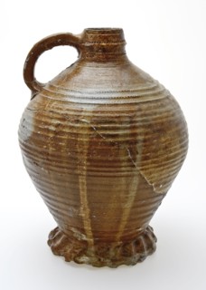 Large stoneware jug on heavy pinched foot, radstamp decoration around neck and shoulder, jug holder kitchen utensils earthenware