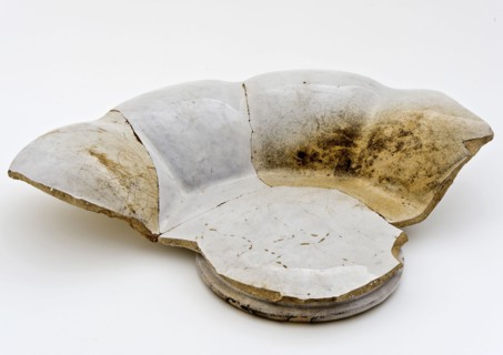 Fragment of white pleated plate on stand, faience, folding dish dish crockery holder fragment soil found ceramic earthenware