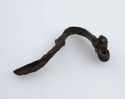 Bronze fibula or cloak pin, narrow curved model, fibula fastener soil find bronze metal, cast drawn bronze fibula or mantle pin
