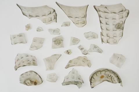 Fragments of soil, stand ring, wall and bramble decoration of waffle cup, beaker tableware holder fragment soil found glass