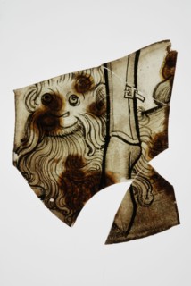 Fragments of green window glass with stained-glass decoration, lion head with long mane, window glass building material soil