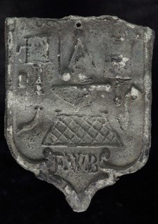 FWB, Roof blank, shield-shaped cover plate with initials FWB and guide tool, plummet lead metal, Roof lead shield-shaped cover