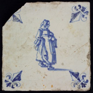 AC, Figure tile, woman with basket on arm, blue decor on white ground, corner filling lily, marked, wall tile tile sculpture