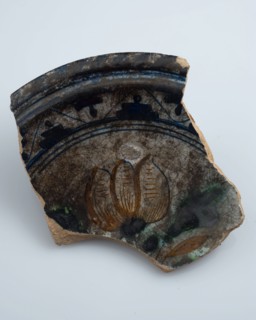 Fragment of majolica dish, polychrome three-tier or flower vase in the mirror, plate crockery holder soil find ceramic
