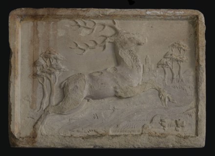 Facing brick with over brook jumping deer in landscape with trees and gate, facing stone sculpture sculpture building component