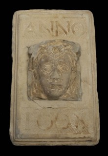 Facing brick with woman's head and text in 1668, facing stone sculpture sculpture building component sandstone stone, sculpted