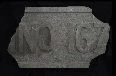 Fragment of facing brick with text ... NO 167 .., facing brick foundation stone building part stone, chopped rectangular frame
