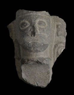 Fragment font with head on starter column, fragment font ornament limestone stone, sculpted Probably fragment of baptismal font