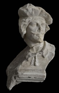 Male head with beret and goatee, sculpture footage limestone stone, sculpted Head of man with mustache goatee and beret.
