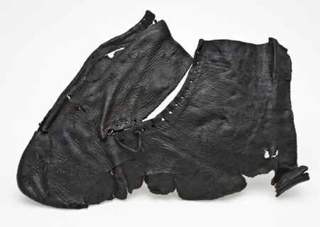 One piece cut upper piece of shoe or half boot with round holes and part of leather lace, shoe footwear clothing soil finding