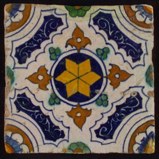 Tile, blue, green, brown and yellow on white, central yellow star in circle, sgraffito surfaces, corner motif, quarter rosette
