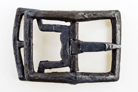 Shoe buckle, rectangular bracket with middle post with angel and bounce, buckle fastener component soil find tin copper? metal