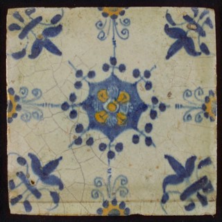 Tile, blue pull and orange on white, central flower within star shape, three-piece around, half rosette, corner pattern lily