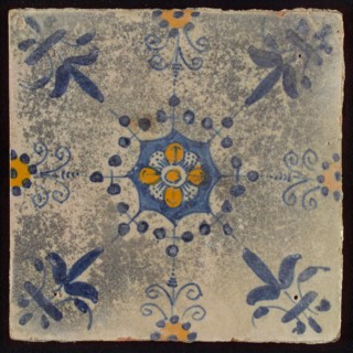 Tile, blue draft and orange on white, central flower within star shape, three-spot around, half rosette, corner pattern lily
