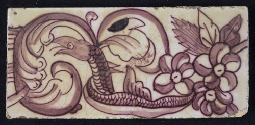 Rectangular edge tile in purple with hinged decor of leaves, flowers and twisted snake with scales and fin, border tile wall