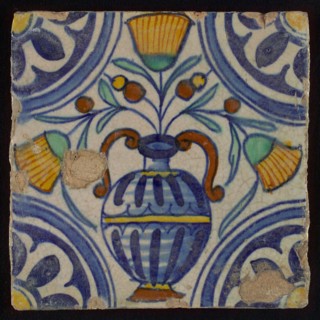 Tile, blue draft, orange, brown, yellow and green on white, central flowerpot with marigolds, corner pattern, rosette, wall tile