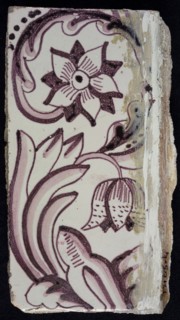Rectangular edge tile in purple with sling-decoration of speckled tulip, flower with ten triangular petals