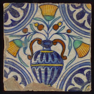 Tile, blue draft, orange, yellow, brown and green on white, central flowerpot with marigolds, corner pattern, rosette, wall tile