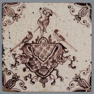 tile manufacturer: Aalmis, Cartouche tile, acrobat with saber and hand on the hat, corner motif spider, wall tile tile sculpture