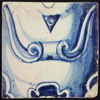 Tile of pilaster, blue on white, part of column with scroll ornament and stylized belly button, tile pilaster footage fragment