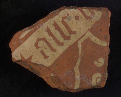 Floor tile, brown and white, wide white band with text in gothic lettering, tile floor tile tile sculpture ceramic earthenware