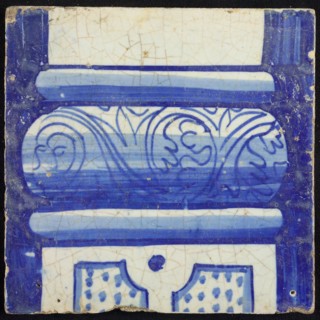 Tile of chimney pilaster, blue on white, bottom of column with basement with curly floral decoration, division with dots