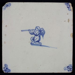 White tile with blue kneeling putto with wind instrument, corner motif spider, wall tile tile sculpture ceramic earthenware